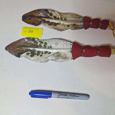 Sale Photo Thumbnail #5: lot of two, they are the same size althought he angle of the photo makes one look larger than the other.  One has a small chip or it is believed to be a chip as the the part of the feather there is not pointed.  These are delicate items, the colors are sl