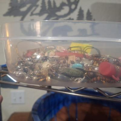 Sale Photo Thumbnail #760: this is a small container of jewelry pieces, it may be broken and mismatches jewelry, there may be a few complete pieces.  No gold or silver