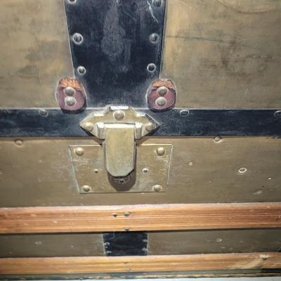 Sale Photo Thumbnail #2: This was probably called a wall trunk instead of a steamer trunk because it opens and the lid stays upright for tighter spqces like trains. Probably manufactured in 1880-1890s, amazing good shape, wheeled, leather straps are broken amd the hinges on yhe i