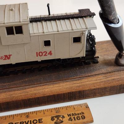 Sale Photo Thumbnail #345: This auction lot is for an L&N Caboose Pen Stand.  This unique desk accessory will look great in the office of any railroad enthusiast.  The pen has some wear and does not write.  The caboose is plastic and it is mounted on a wood base.  See photo for siz