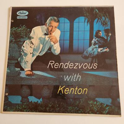 Sale Photo Thumbnail #379: This auction lot is for an Autographed Stan Kenton Vinyl Record.  The record appears to be in good condition but has not been played by us.  The cardboard sleeve has seen some wear and has some edge splitting and aging to it.  Given to our client who was 