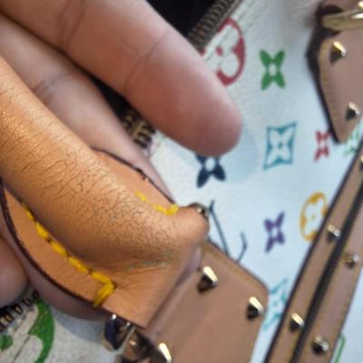 Sale Photo Thumbnail #838: Beautiful Louis Vuitton handbag.  Please see all photos.  We believe it to be authentic.   It is a little stiff.  The zipper works well.  We do not have the long shoulder strap or the  dust bag