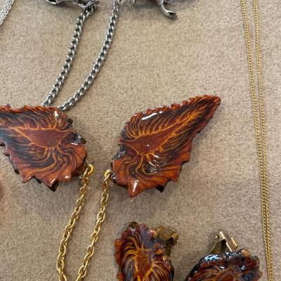Two sweater guards, two necklaces and hair clip