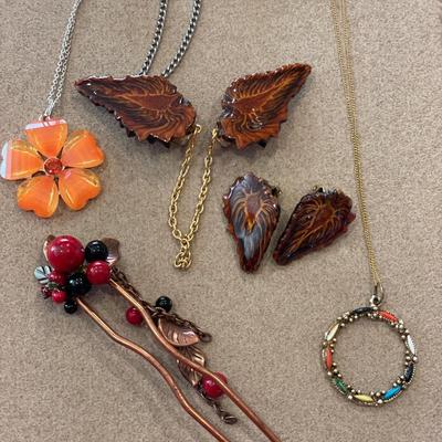 Two sweater guards, two necklaces and hair clip