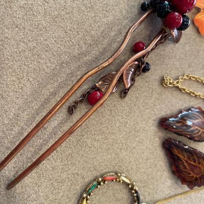 Two sweater guards, two necklaces and hair clip