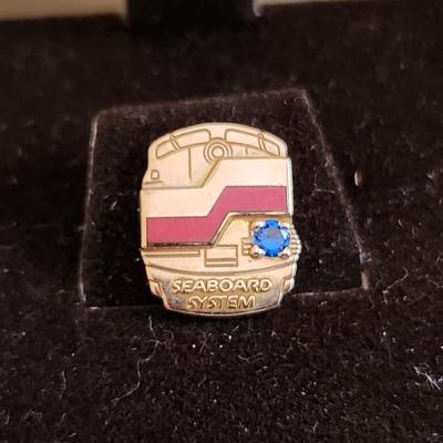 Sale Photo Thumbnail #500: This auction lot is for a Seaboard Railroad System Gold Service Pin with Jewel.  The pin/tie tack is marked 10K on the verso.  Great for most any railroad collector. Nice gem stone.