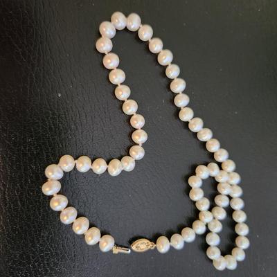 Sale Photo Thumbnail #505: This auction lot is for a Cultured Pearl Necklace.  This stunning necklace is made of real cultured pearls - hand tied between each.  The necklace has a 14K gold clasp.  It measures about 18-inches long.  Very Nice.