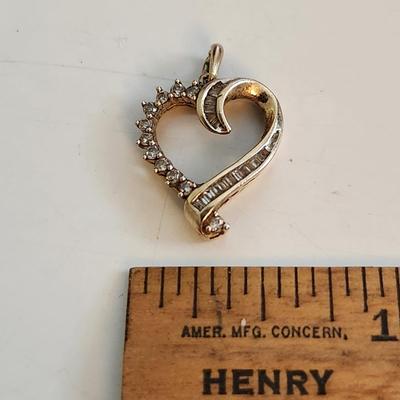 Sale Photo Thumbnail #509: This auction lot is for a Diamond & Gold (?) Pendant.  This item is not marked - however, we believe it to be gold with diamond chips.  The chips test as diamonds.  The gold looks and feels real but has not been tested.  The buyer must decide for themselv