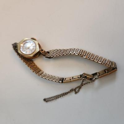 Sale Photo Thumbnail #519: This auction lot is for a Ladies Rado Gold Watch.  The watch is marked 10KGF.  The very pretty watch band to which it is attached is marked Speidel and also marked 10KGF.  Rado watches are Swiss made - the watch is not running at this time. This watch is 