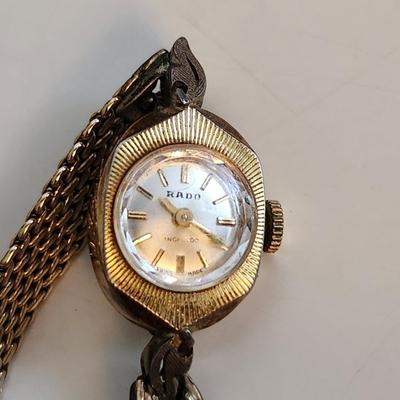 Sale Photo Thumbnail #520: This auction lot is for a Ladies Rado Gold Watch.  The watch is marked 10KGF.  The very pretty watch band to which it is attached is marked Speidel and also marked 10KGF.  Rado watches are Swiss made - the watch is not running at this time. This watch is 