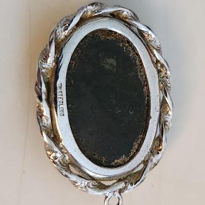 Sale Photo Thumbnail #525: This auction lot is for a Red Vein Jasper Stone Pendant Set in Sterling Silver.  Our resident gem person tells us this stone is either Red Vein Jasper or Black Vein Rhodonite - either way it is a nice stone and with its sterling silver case would look stu