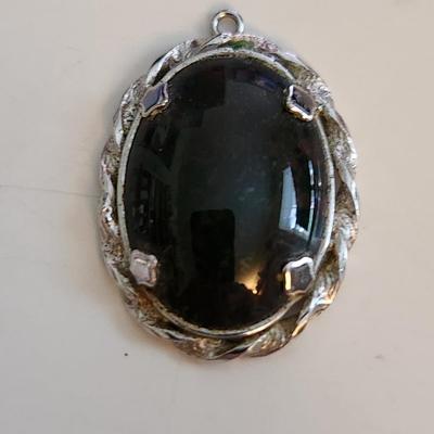 Sale Photo Thumbnail #522: This auction lot is for a Red Vein Jasper Stone Pendant Set in Sterling Silver.  Our resident gem person tells us this stone is either Red Vein Jasper or Black Vein Rhodonite - either way it is a nice stone and with its sterling silver case would look stu