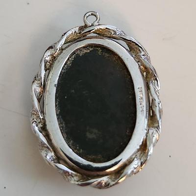 Sale Photo Thumbnail #524: This auction lot is for a Red Vein Jasper Stone Pendant Set in Sterling Silver.  Our resident gem person tells us this stone is either Red Vein Jasper or Black Vein Rhodonite - either way it is a nice stone and with its sterling silver case would look stu