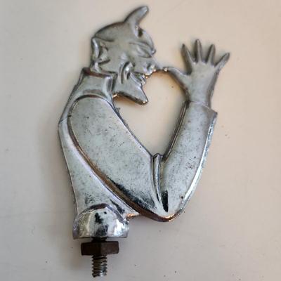 Sale Photo Thumbnail #55: This auction lot is for a Devil Hood Ornament.  The devil you say - as he razzes you back. This nifty find would look perfect mounted on so many things - from you car or bike to who know what.  Chrome plated metal with screw base.  See photo for size.  Wh