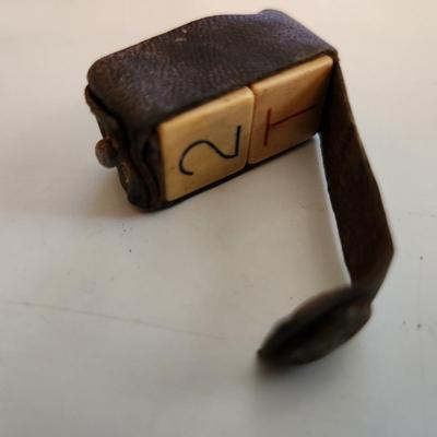 Sale Photo Thumbnail #60: This auction lot is for Vintage Die Game in Leather Pouch.  We don't know the game this item is used to play - if you do please educate us.  Whatever it is a neat find and a great curiosity to hold.