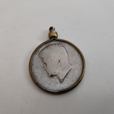 Sale Photo Thumbnail #526: This auction lot is for a Well-Worn Kennedy Half Dollar Watch Fob.  The encasement ring "might" be gold but it is not marked.  Used by an L&N Railroad Train Conductor for many years.