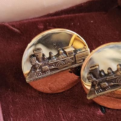 Sale Photo Thumbnail #570: This auction lot is for a set of Vintage Locomotive Cuff Links.  They have a nice design and good coloration.  No markings.