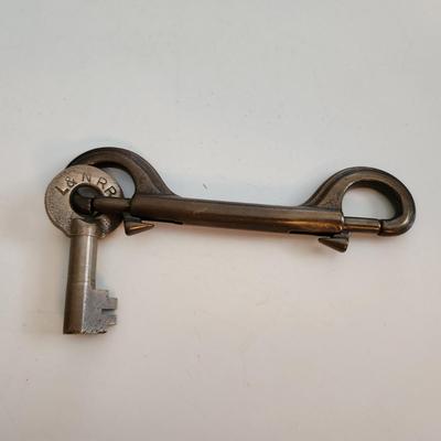 Sale Photo Thumbnail #50: This auction lot is for a L&N Railroad Master Key.  This master key is marked and is hanging on a heavy metal clip holder - the key is easily removed.