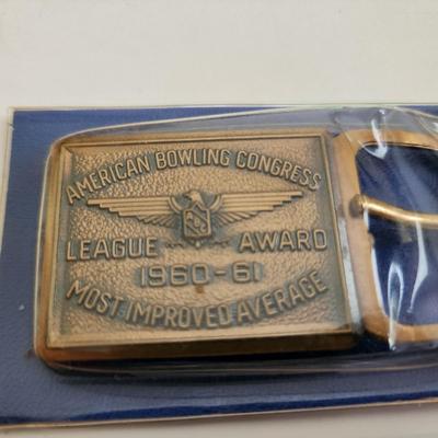 Sale Photo Thumbnail #587: This auction lot is for an American Bowling Congress Belt Buckle Award.  Dated 1960-61 this award is for the most improved average.  Nice old bowling collectible.  Still in it's original plastic covering.