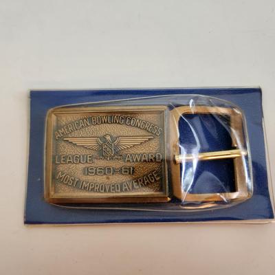 Sale Photo Thumbnail #585: This auction lot is for an American Bowling Congress Belt Buckle Award.  Dated 1960-61 this award is for the most improved average.  Nice old bowling collectible.  Still in it's original plastic covering.