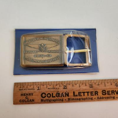 Sale Photo Thumbnail #586: This auction lot is for an American Bowling Congress Belt Buckle Award.  Dated 1960-61 this award is for the most improved average.  Nice old bowling collectible.  Still in it's original plastic covering.