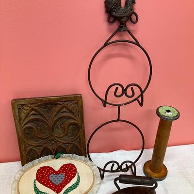 Sale Photo Thumbnail #98: Grouping of a rooster plate holder, vintage iron, vintage wooden spool, a ceramic decorative tile, and a quilted heart decor piece