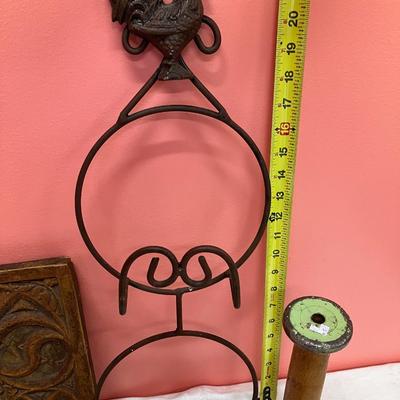 Sale Photo Thumbnail #101: Grouping of a rooster plate holder, vintage iron, vintage wooden spool, a ceramic decorative tile, and a quilted heart decor piece