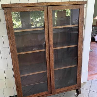Vintage double-door rolling glass cabinet/bookshelf