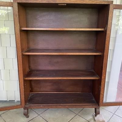 Vintage double-door rolling glass cabinet/bookshelf
