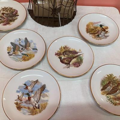 Sale Photo Thumbnail #143: Grouping of 6 collectible bird plates, a bird cage votive candle holder, and a collectible bald eagle figurine