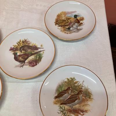 Sale Photo Thumbnail #148: Grouping of 6 collectible bird plates, a bird cage votive candle holder, and a collectible bald eagle figurine