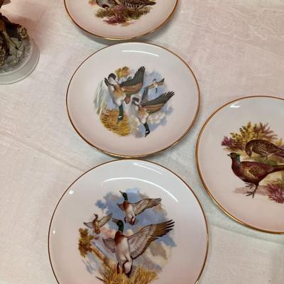 Sale Photo Thumbnail #149: Grouping of 6 collectible bird plates, a bird cage votive candle holder, and a collectible bald eagle figurine