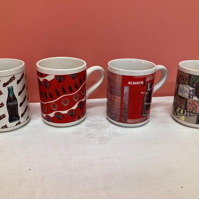 Sale Photo Thumbnail #199: Set of 6 varied Coca-Cola mugs and a Coca-Cola santa tin with playing cards in original box