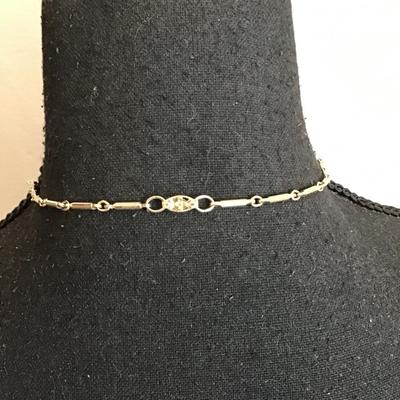 Sale Photo Thumbnail #123: Beautiful, gold tone, vintage choker style necklace with beautiful gold tone, pendant with red rhinestones. Please see attached photos.