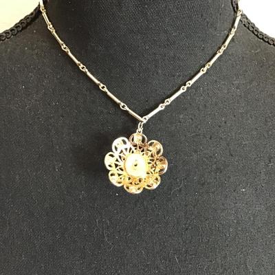 Sale Photo Thumbnail #122: Beautiful, gold tone, vintage choker style necklace with beautiful gold tone, pendant with red rhinestones. Please see attached photos.