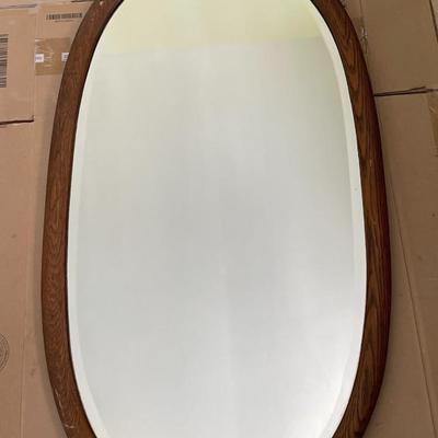 Oval wood framed wall mirror