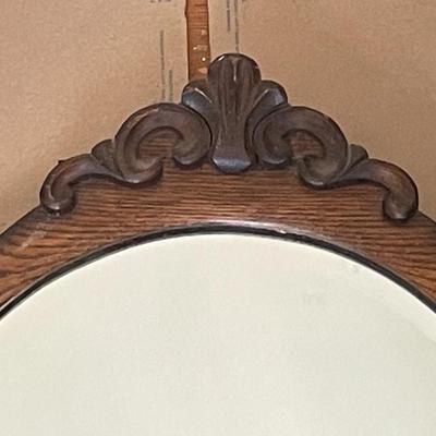 Oval wood framed wall mirror