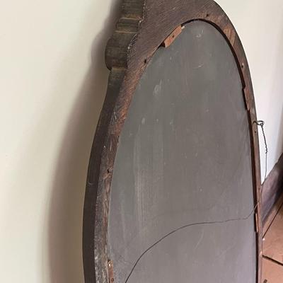 Oval wood framed wall mirror