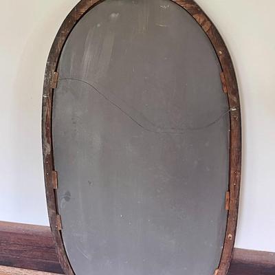 Oval wood framed wall mirror