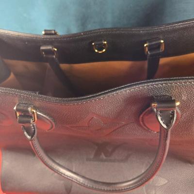 Sale Photo Thumbnail #37: This auction lot is for a Faux Louis Vuitton "On the Go Bag."  It is a quality knock off.  We didn't find any serial numbers inside so we assume it is a fake.  It appears used lightly. Inside is very clean and looks like suede.  There is some light eviden