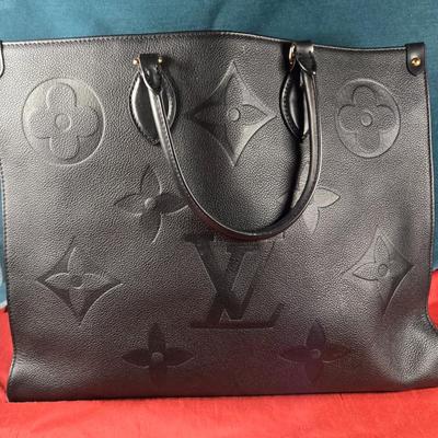 Sale Photo Thumbnail #30: This auction lot is for a Faux Louis Vuitton "On the Go Bag."  It is a quality knock off.  We didn't find any serial numbers inside so we assume it is a fake.  It appears used lightly. Inside is very clean and looks like suede.  There is some light eviden