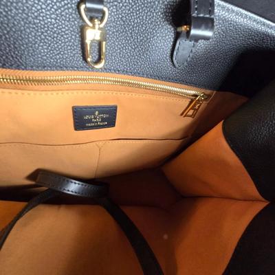 Sale Photo Thumbnail #33: This auction lot is for a Faux Louis Vuitton "On the Go Bag."  It is a quality knock off.  We didn't find any serial numbers inside so we assume it is a fake.  It appears used lightly. Inside is very clean and looks like suede.  There is some light eviden