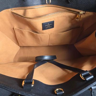 Sale Photo Thumbnail #34: This auction lot is for a Faux Louis Vuitton "On the Go Bag."  It is a quality knock off.  We didn't find any serial numbers inside so we assume it is a fake.  It appears used lightly. Inside is very clean and looks like suede.  There is some light eviden