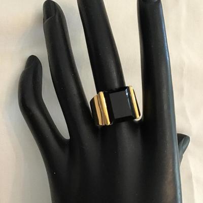 Sale Photo Thumbnail #76: Beautiful gold tone ring with black glass size 9. Please see attached photos.