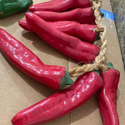 Two strings of ceramic peppers