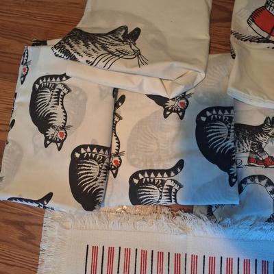 Sale Photo Thumbnail #198: These don't appear to have ever been used however the elastic in both fitted sheets are crumbly and wouldn't work well.  There are two sheet sets, one with the sitting cat and one with the cat wearing red shoes.  Both sets have the pillowcase as cat with 
