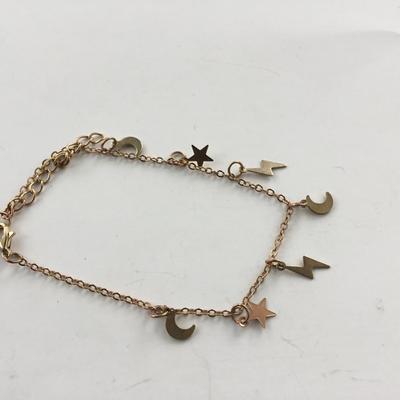 Gold tone stars and lightening bolt charm bracelet