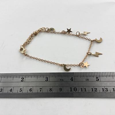 Gold tone stars and lightening bolt charm bracelet
