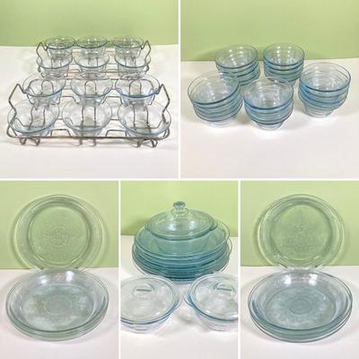 LOT 179: Large Fire King Oven Glass Collection - 2 Racks with Custard Cups, Plates, Small Lidded Bowls and Individual Custard Cups