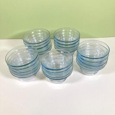 LOT 179: Large Fire King Oven Glass Collection - 2 Racks with Custard Cups, Plates, Small Lidded Bowls and Individual Custard Cups